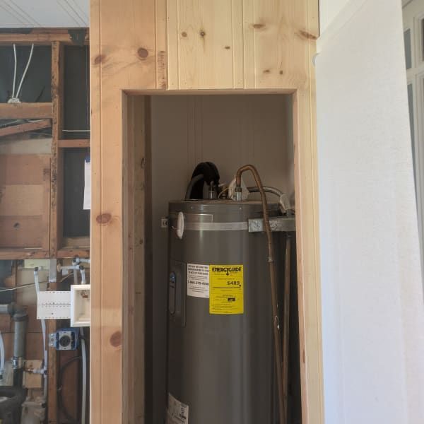 Water heater recessed in a wood-framed wall niche during construction