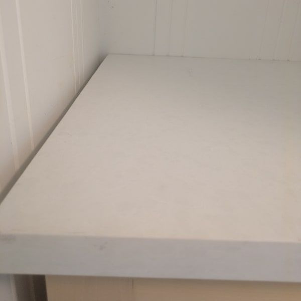 White countertop shelf in a plain white corner of a room