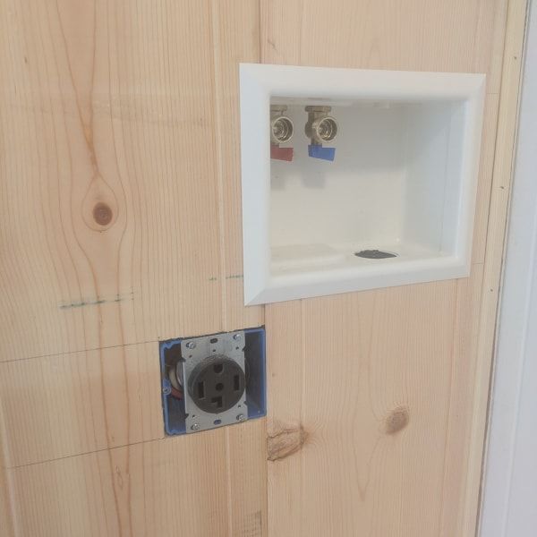 Wall with a white recessed shelf niche above an electrical outlet.