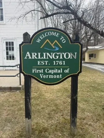 Green Arlington, Vermont welcome sign reading “Est. 1761, First Capital of Vermont”