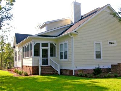 The back of a house with a screened in porch