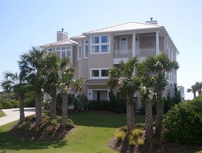 A large house with palm trees in front of it