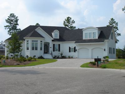 A large white house with a black roof