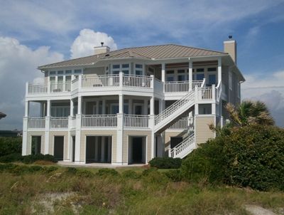 A large white house with many balconies and stairs