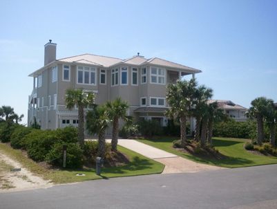 A large house with palm trees in front of it