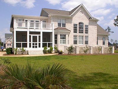 A large white house with a screened in porch