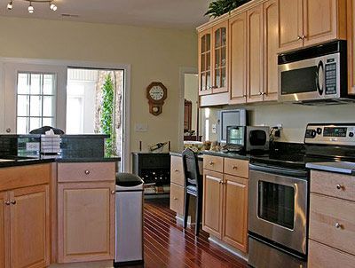 A kitchen with stainless steel appliances and wooden cabinets
