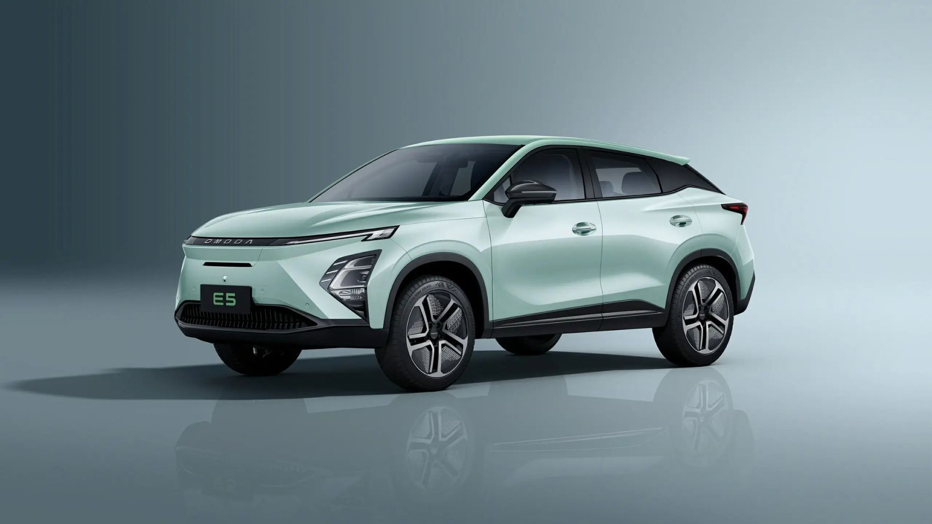 Mint green SUV in a studio setting, shown in side view on a gray background.