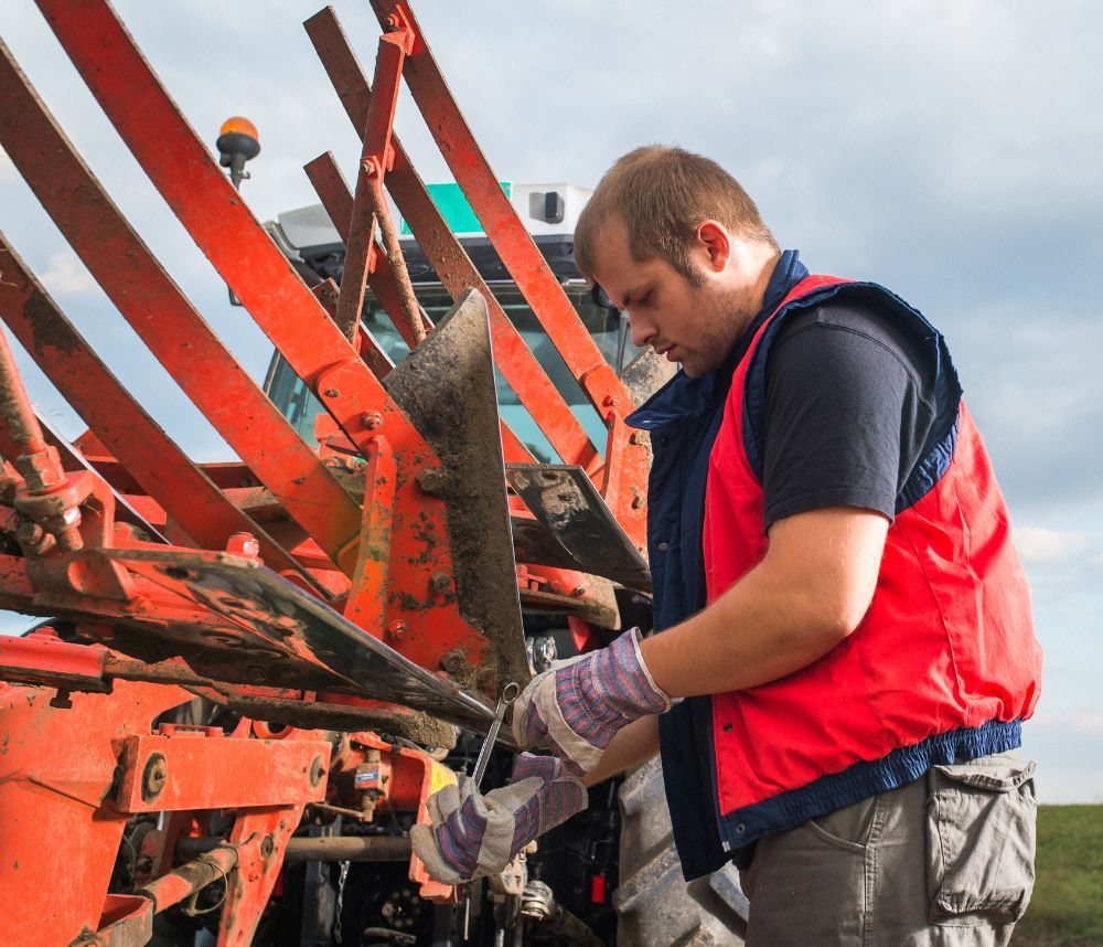 Fixing Tractor — Saint Joseph, MO — Render Auto Glass Inc. Fixing Tractor — Saint Joseph, MO — Render Auto Glass Inc.