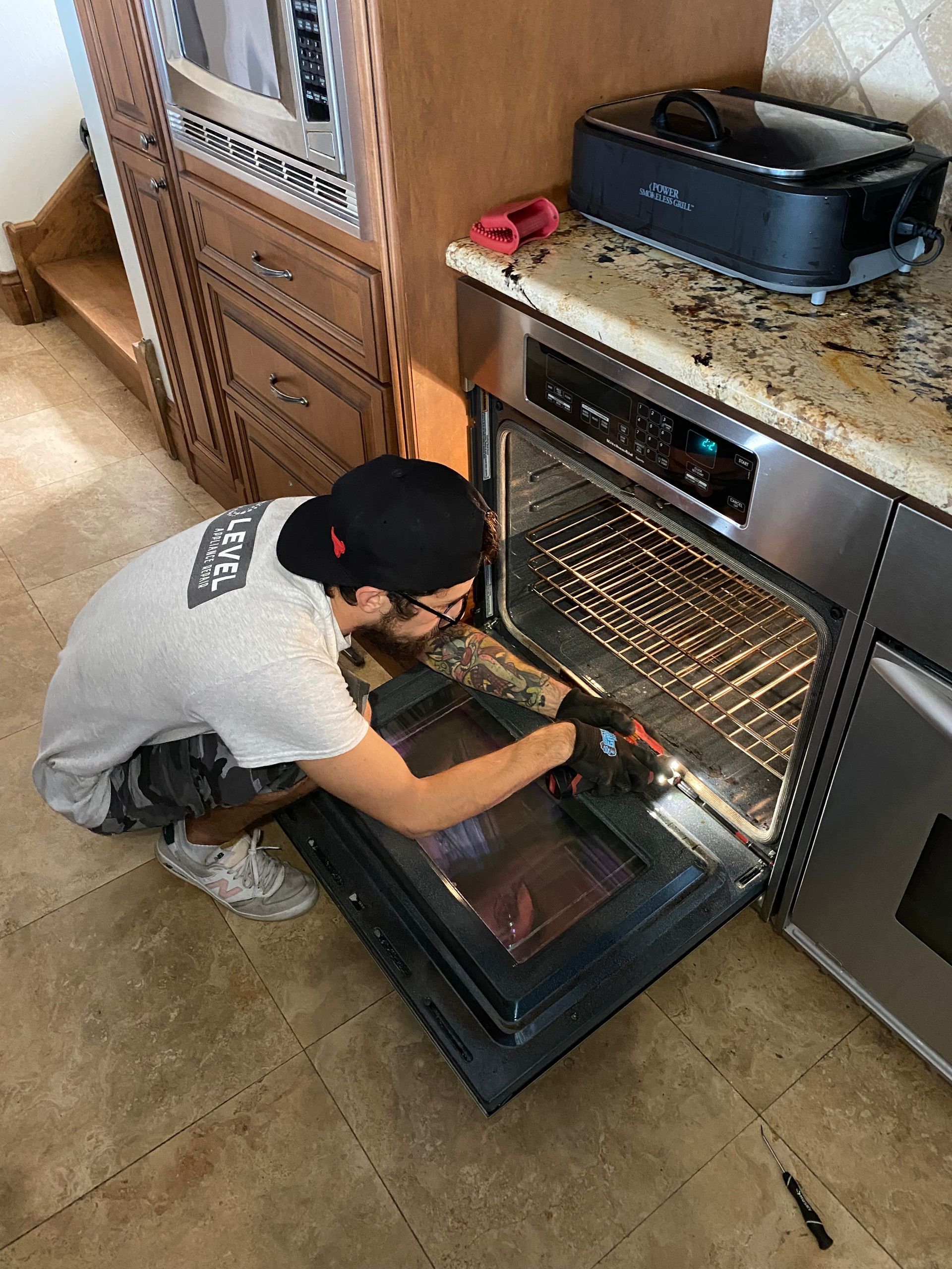 Person cleaning the inside of an oven in a kitchen.