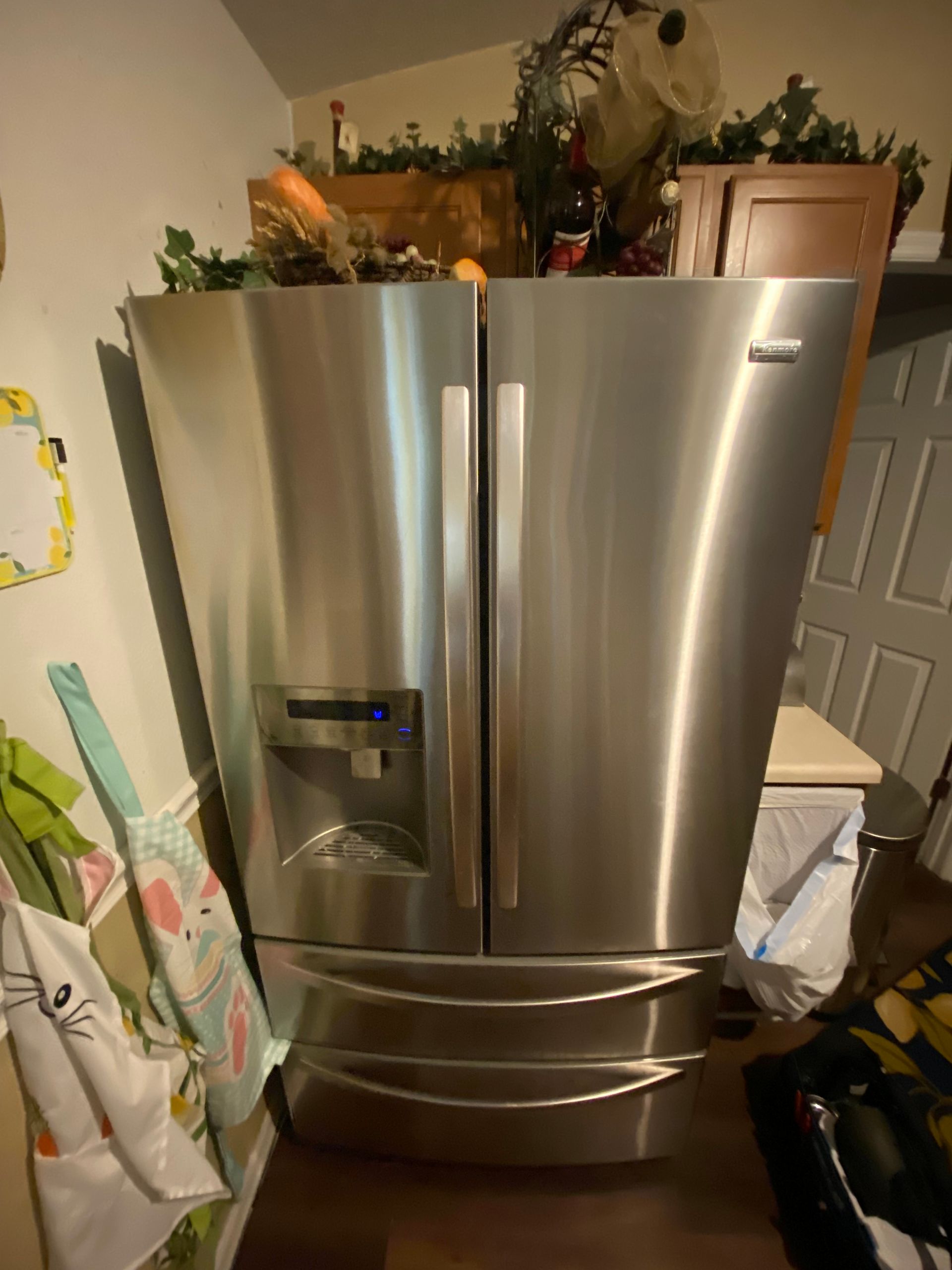 Stainless steel French door refrigerator in a kitchen.