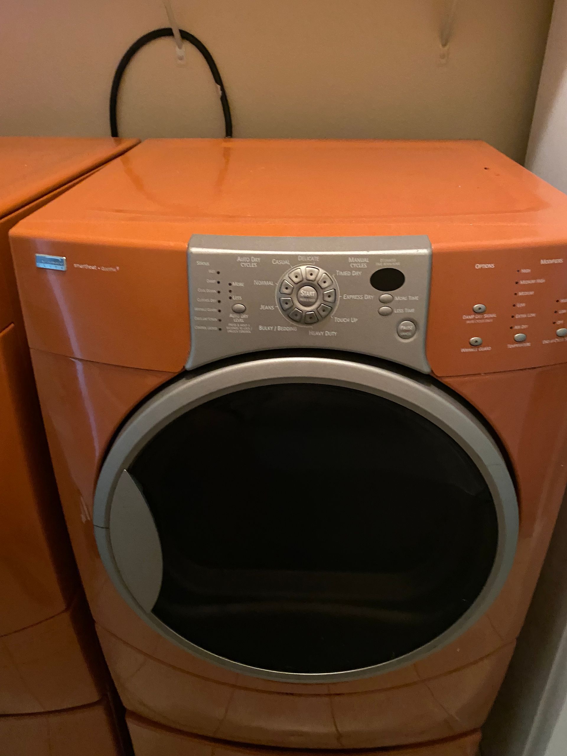 Orange Kenmore dryer with a silver control panel.