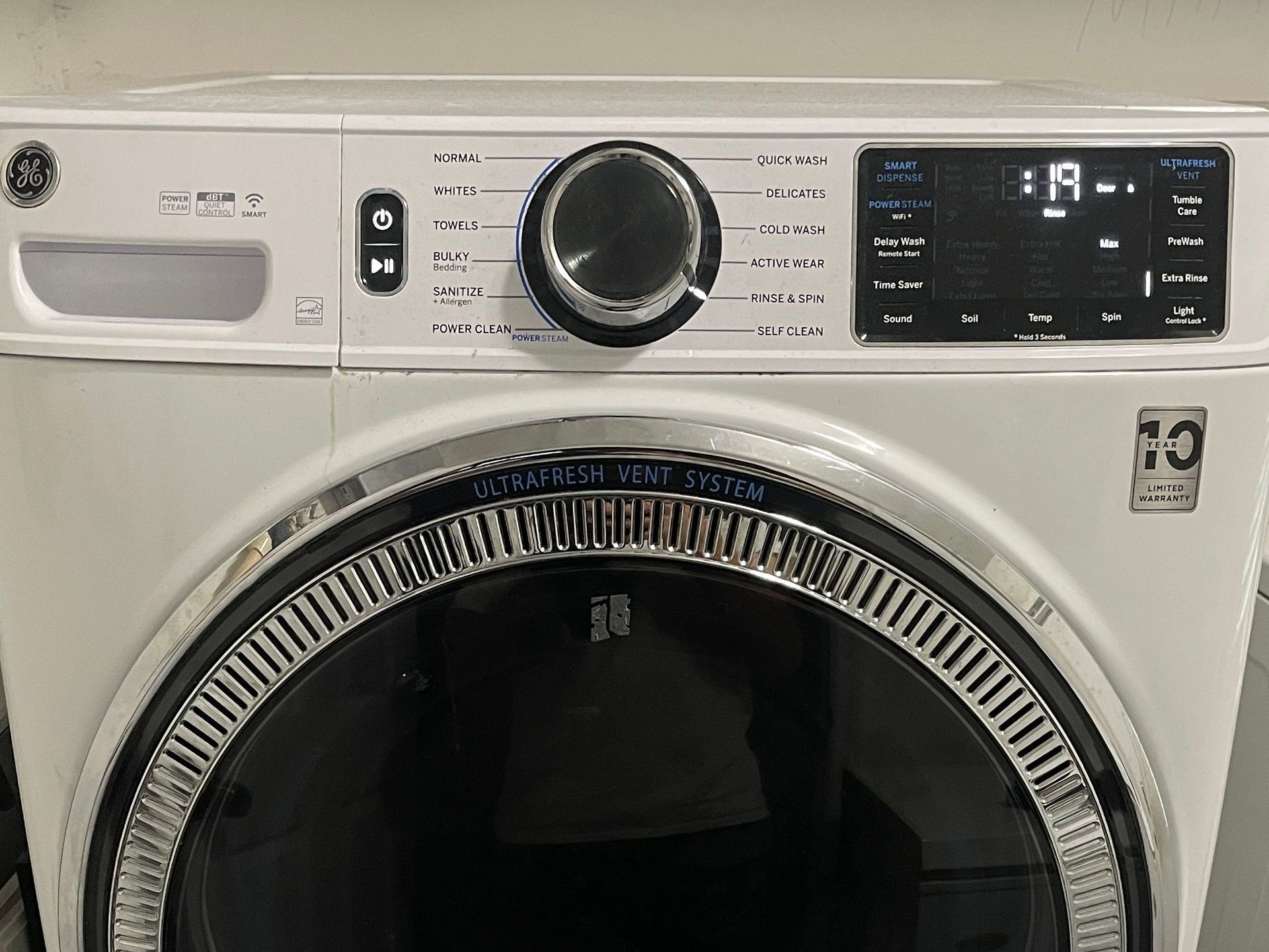 White GE dryer with a control panel and digital display.