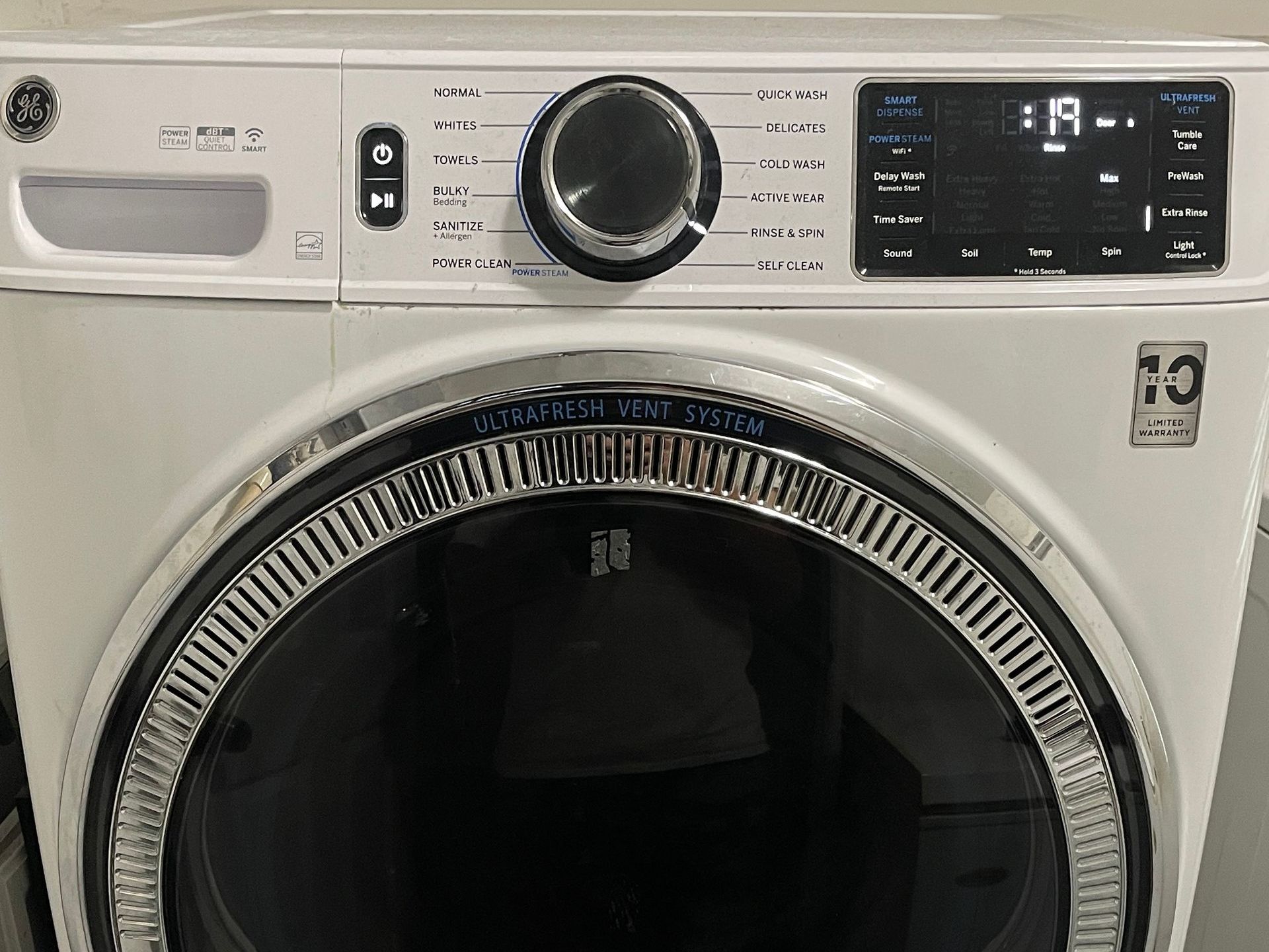 White GE dryer with a control panel and digital display.