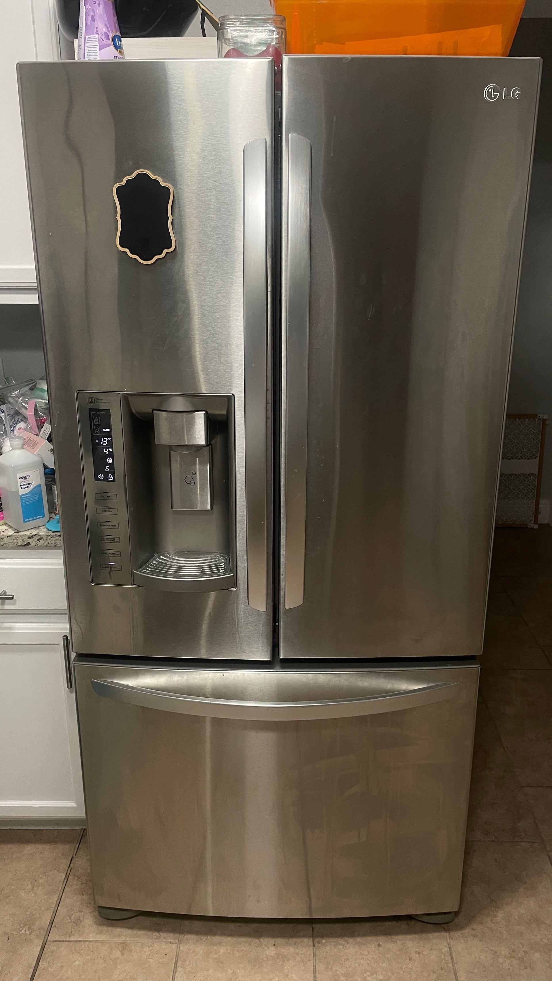 Stainless steel LG refrigerator with French doors and a bottom freezer.