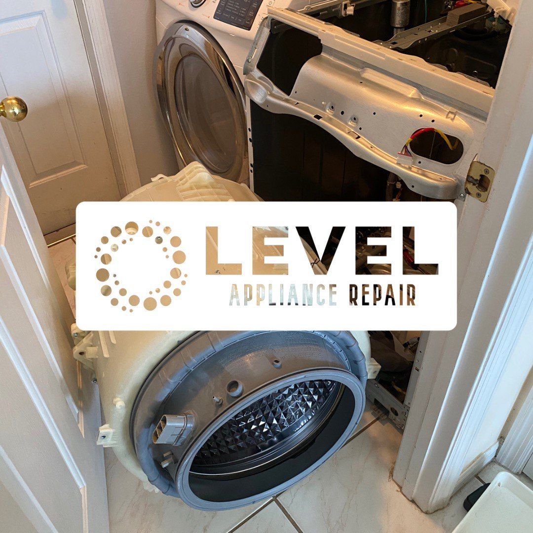 Washing machine disassembled in a doorway, with Level Appliance Repair logo overlaid.
