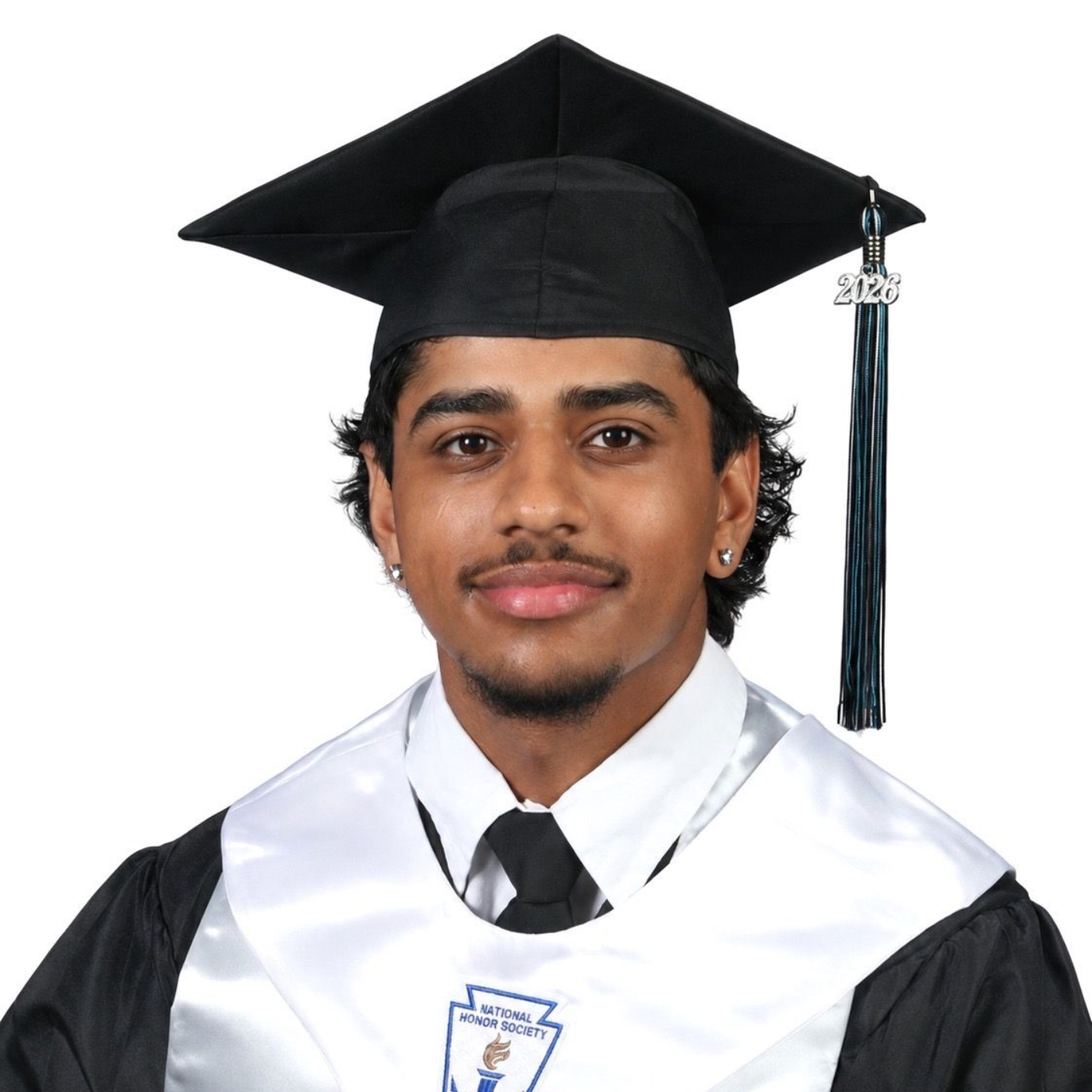 Graduate in black cap and gown with white stole, facing forward and smiling.