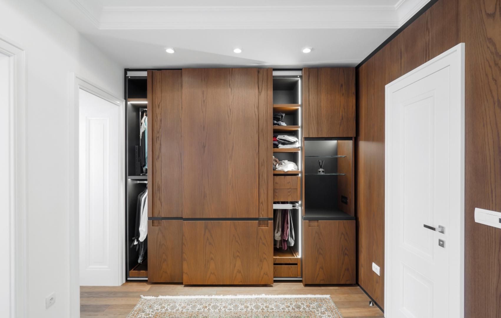 A Walk in Closet with Sliding Wooden Doors in A Hallway — Smith's Joinery in Casino, NSW