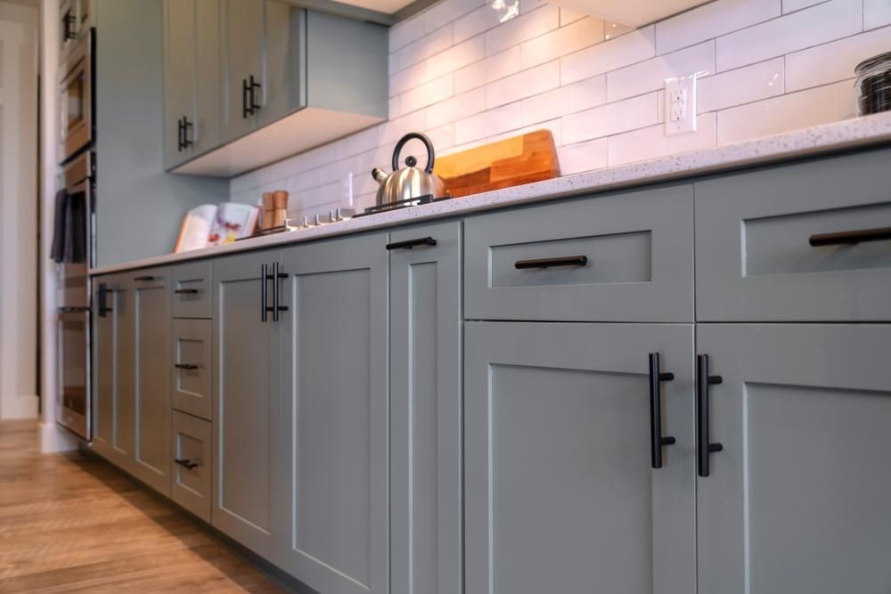 A Kitchen with Gray Cabinets and Black Handles and A Sink — Smith's Joinery in Murwillumbah, NSW