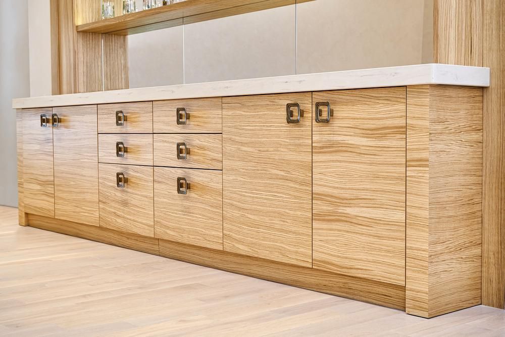 A Kitchen with Wooden Cabinets and Drawers and A White Counter Top — Smith's Joinery in Lismore, NSW