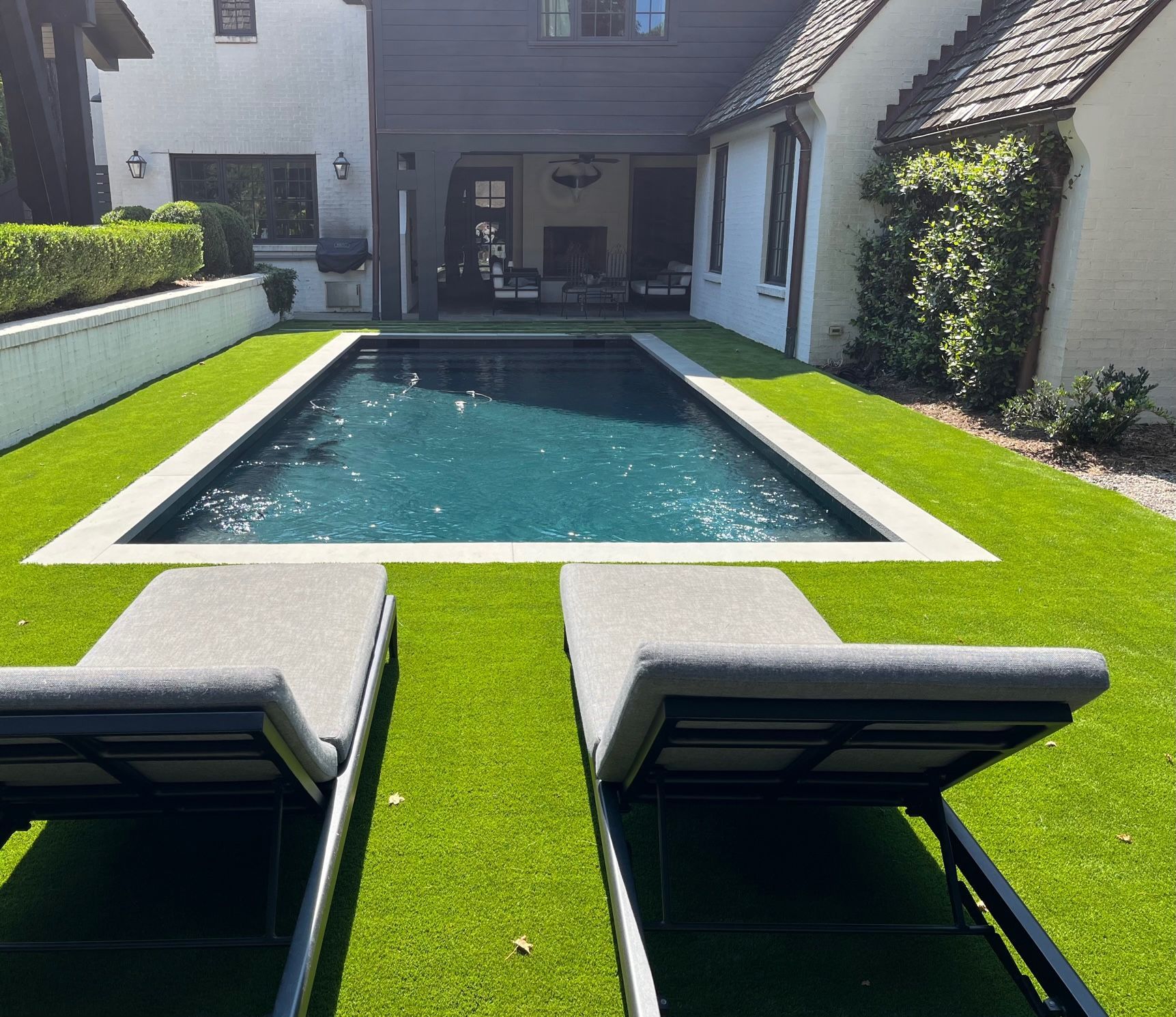 A large swimming pool in the backyard of a house
