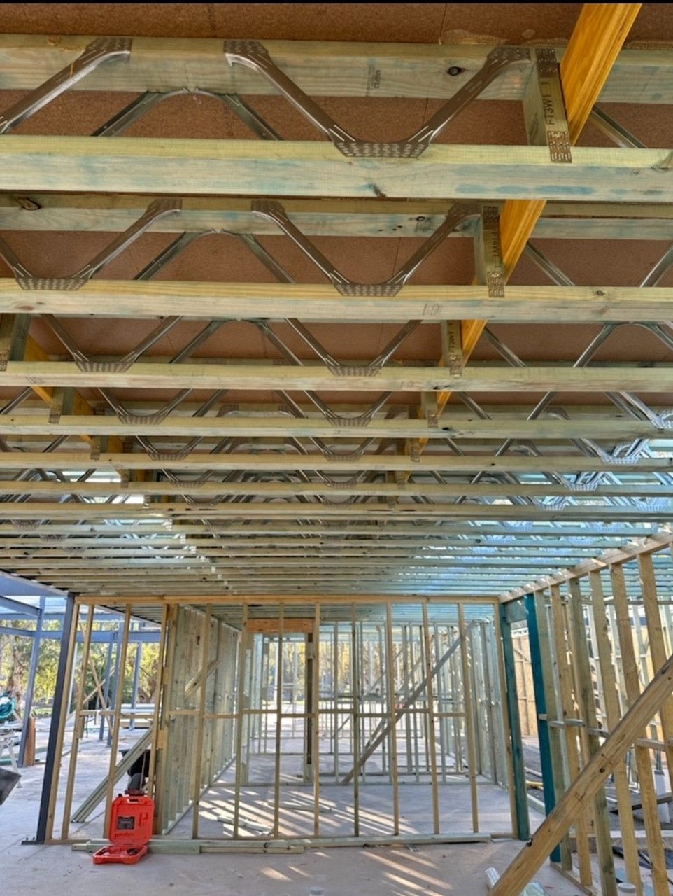 The inside of a building under construction with wooden beams.