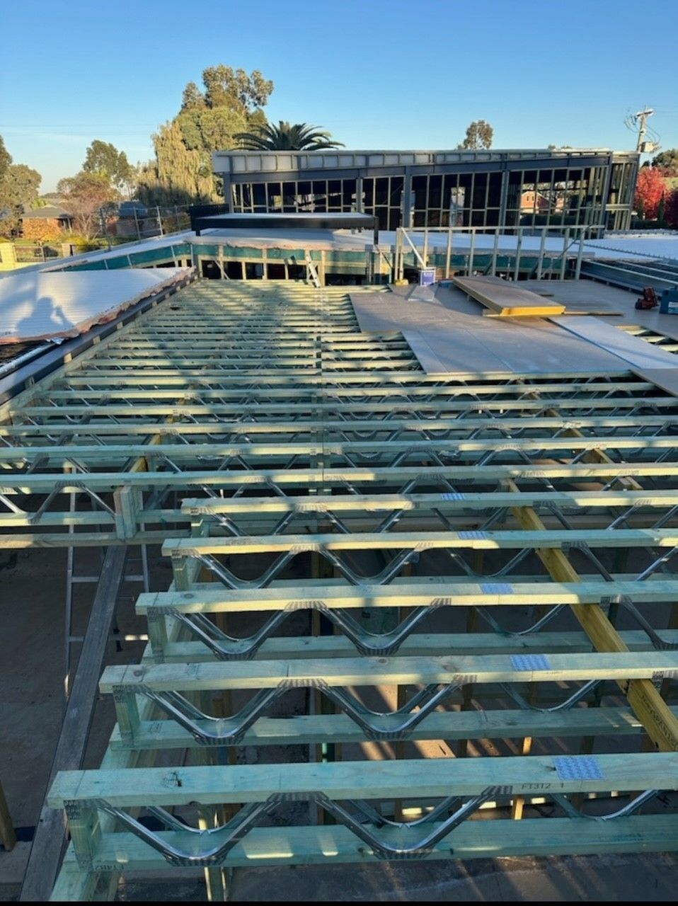 A large wooden structure is being built on top of a building.