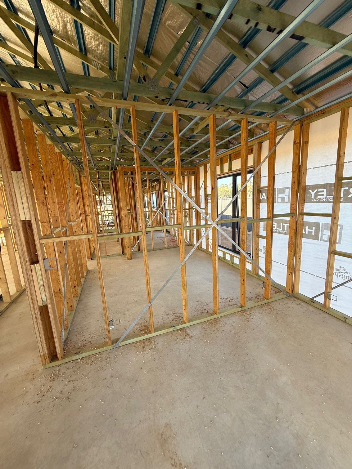 The inside of a building under construction with a lot of wooden beams.