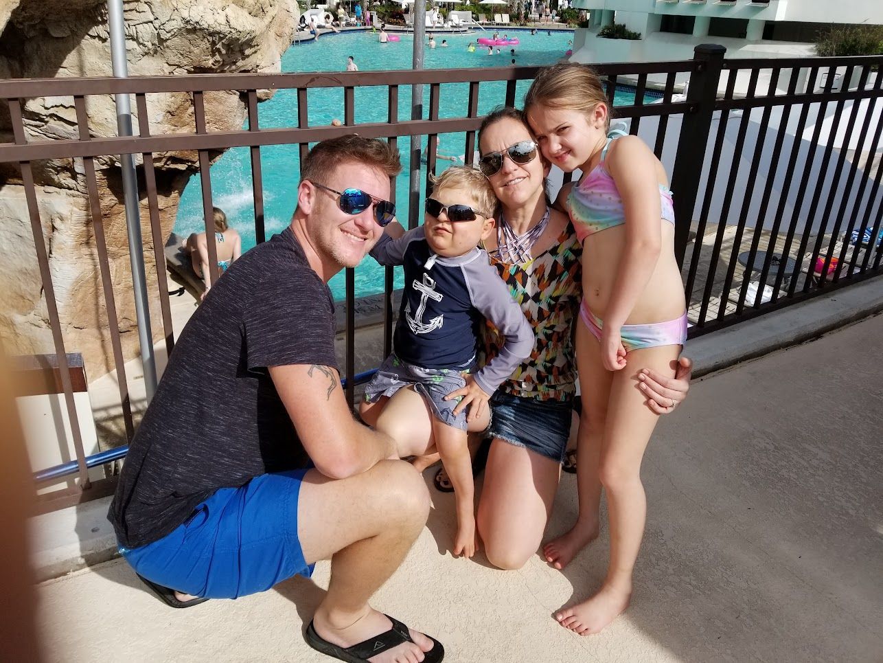 A family posing for a picture in front of a pool florida world center mariott Cole Kubista