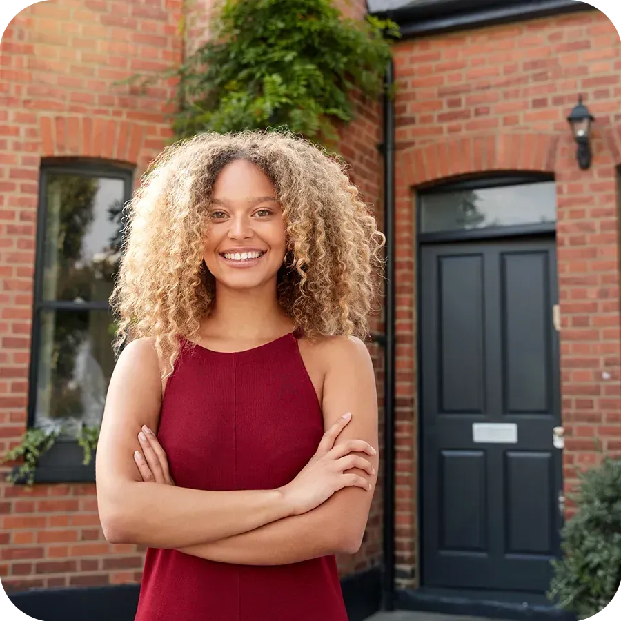 Happy property investor stood in front of a property