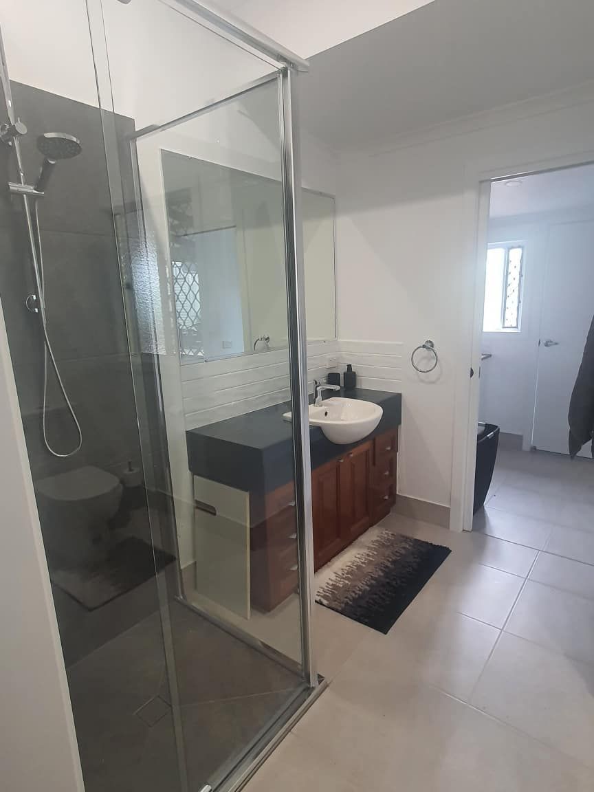 A Bathroom with A Sink, Toilet and Shower — Formosa Building And Renovations in Childers, QLD