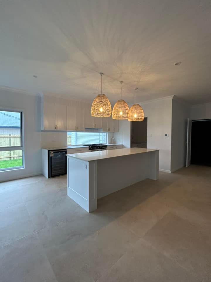 An Empty Kitchen with A Large Island in The Middle of The Room — Formosa Building And Renovations in Childers, QLD