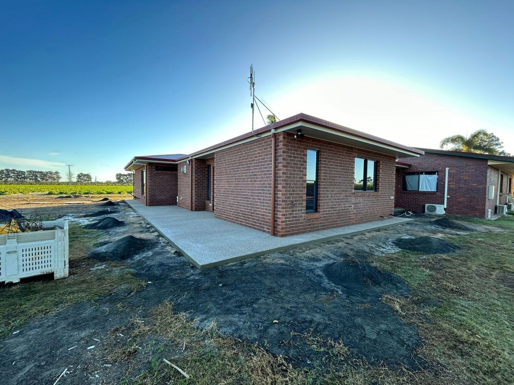 Brown Brick House In Open Area — Formosa Building And Renovations in Kensington, QLD