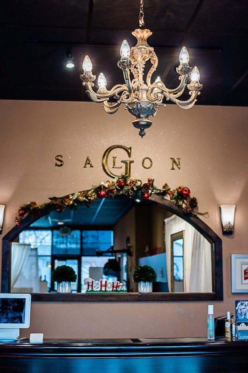 Decorative restaurant interior with “Saigon” sign, chandelier, and arched mirror behind the bar