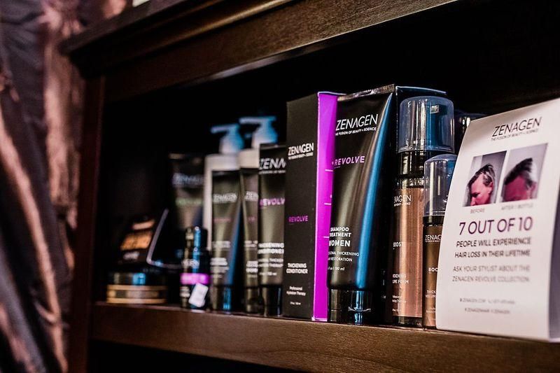 Shelf of hair care products, including black and purple bottles and a white 7 Out of 10 card.