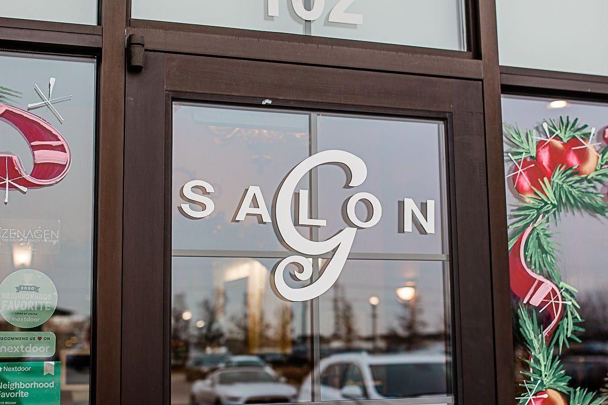 Salon storefront with glass doors, “SALON” sign, and holiday decorations including strawberries and greenery