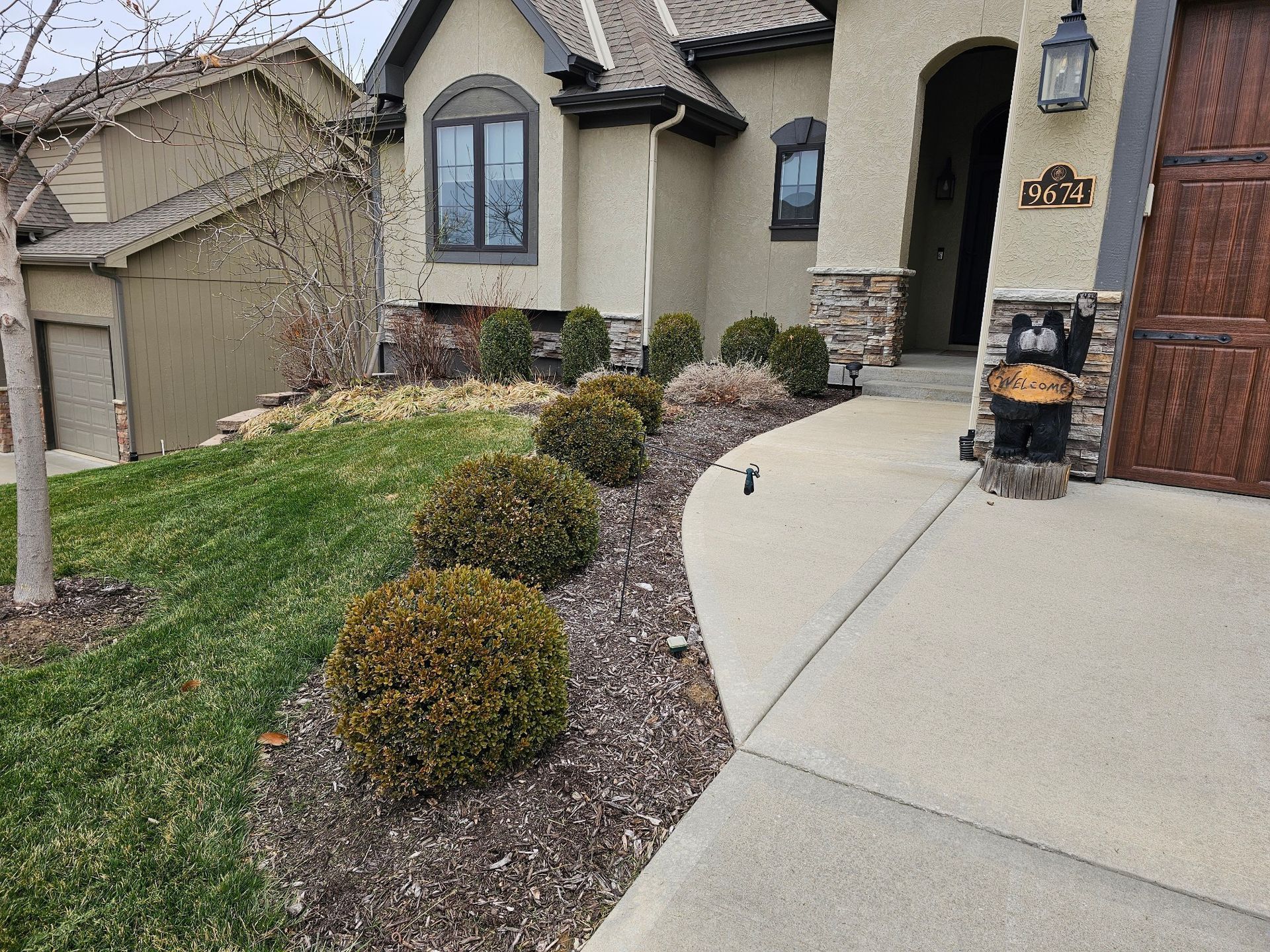 Freshly landscaped yard with decorative rock beds and healthy green grass