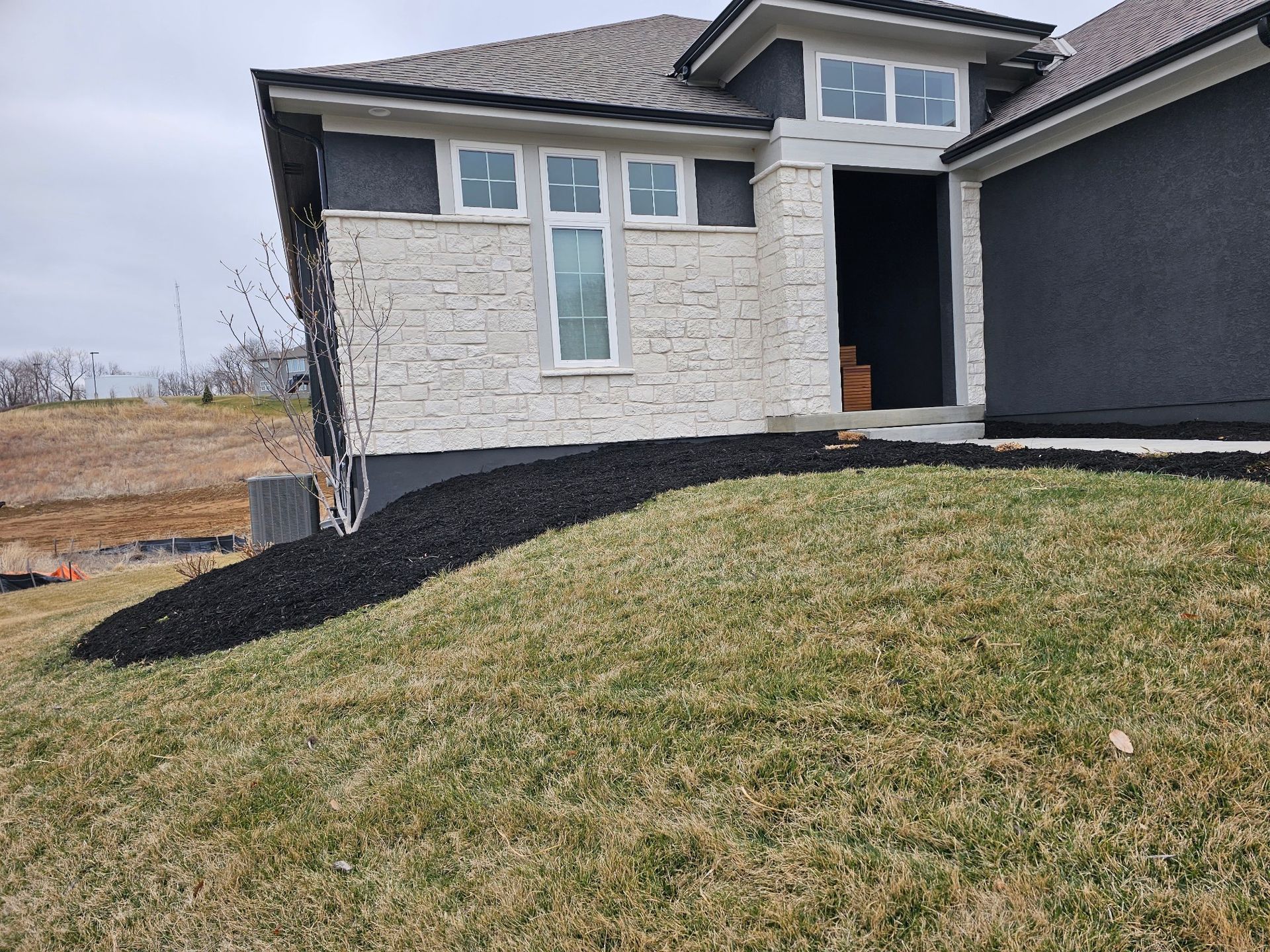 Professional landscaping work adding rock features to enhance curb appeal
