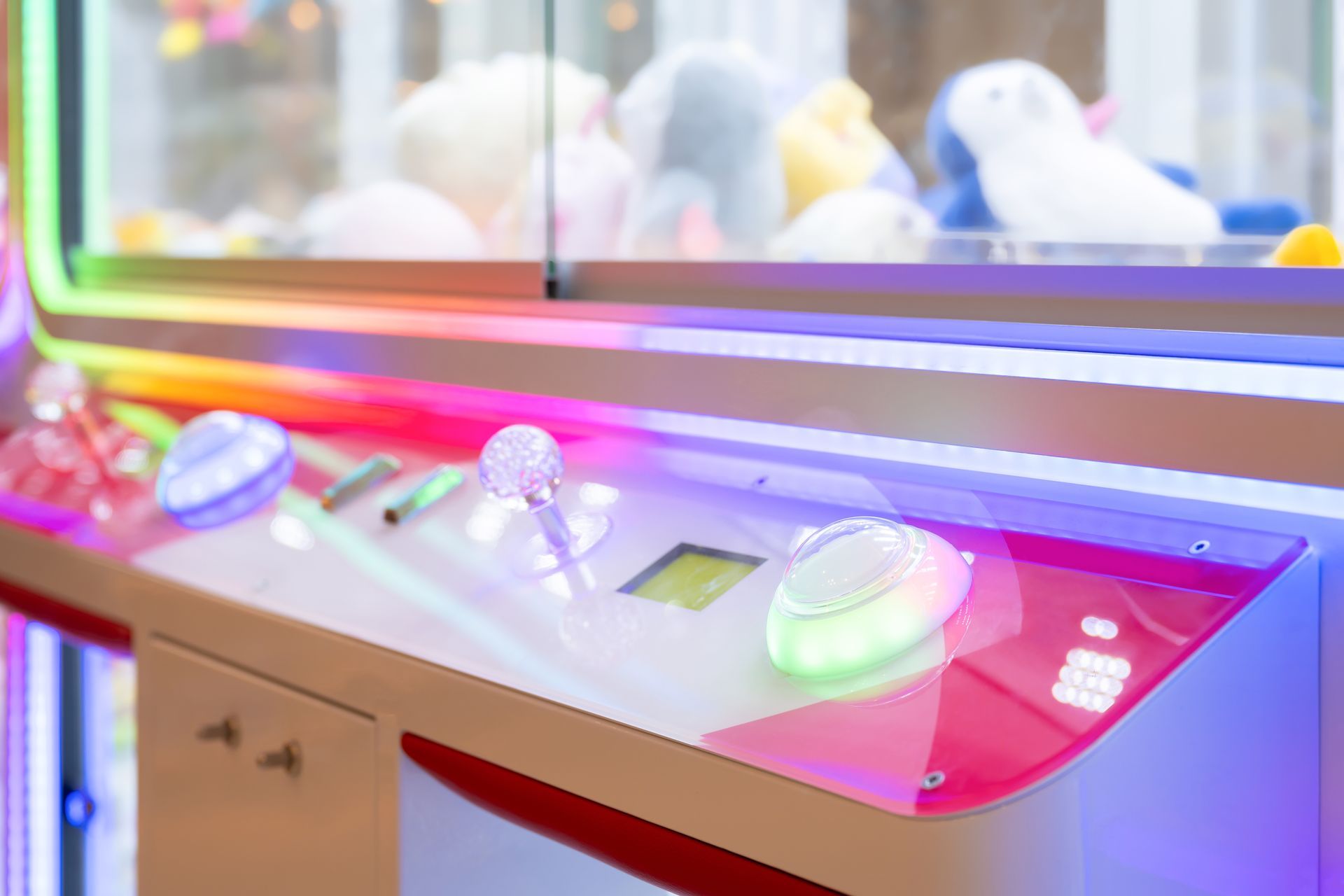 Colorful arcade claw machine controls with glowing buttons and LED lights