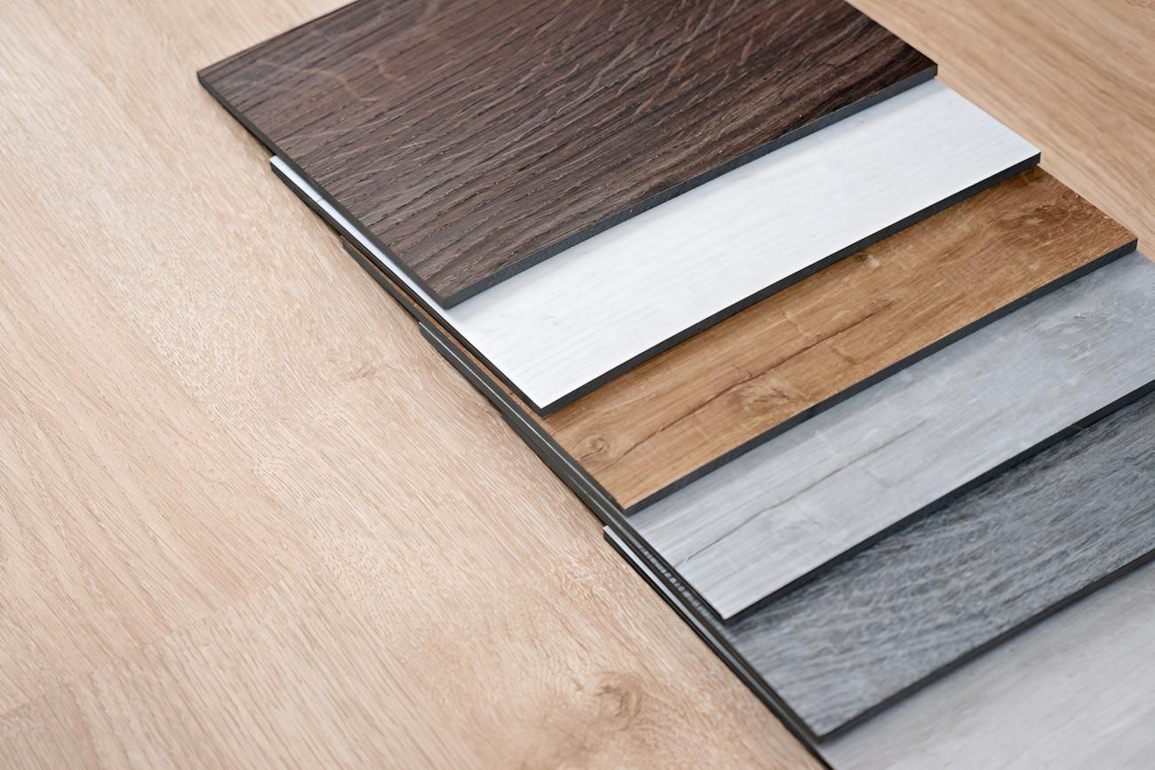 Stack of Different Vinyl Planks on a Wooden Floor — Affordable Carpets & Mats in Burpengary, QLD