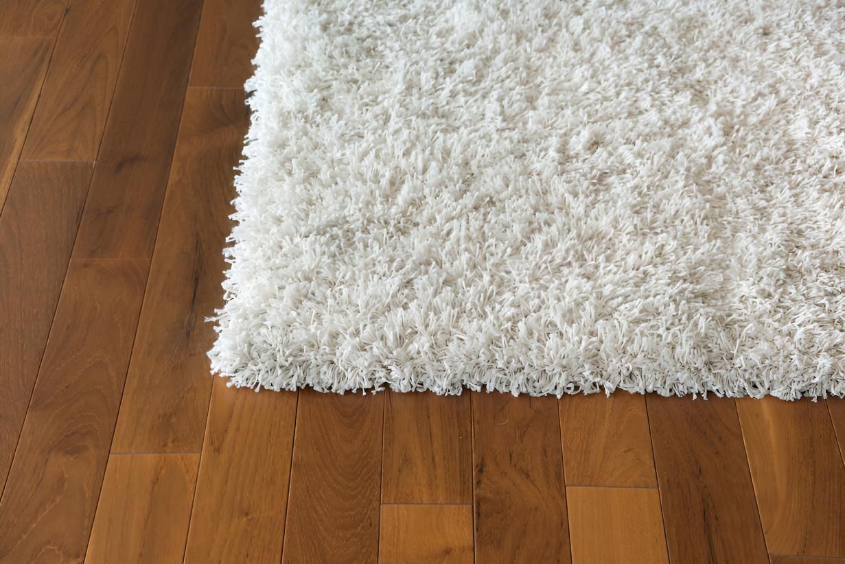 White Carpets is Sitting on a Wooden Floor — Affordable Carpets & Mats in Caboolture, QLD