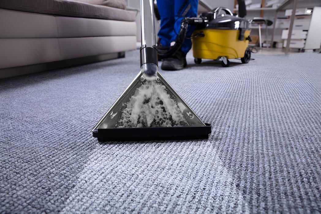 Person is Cleaning a Carpet With a Vacuum Cleaner — Affordable Carpets & Mats in Caboolture, QLD