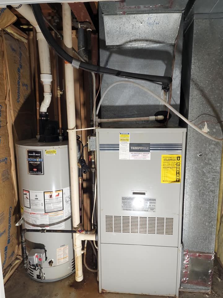 A water heater and an air conditioner in a basement