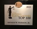 A sign that says top 100 black lawyers with a statue of justice on it.