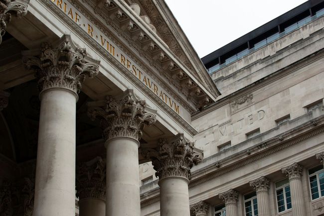 The front of a building with columns and a sign that says ' r.vm. bestiarius ' on it.
