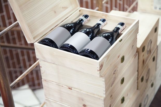 Wooden crate filled with dark glass bottles at a warehouse stack Wooden crate filled with dark glass bottles at a warehouse stack