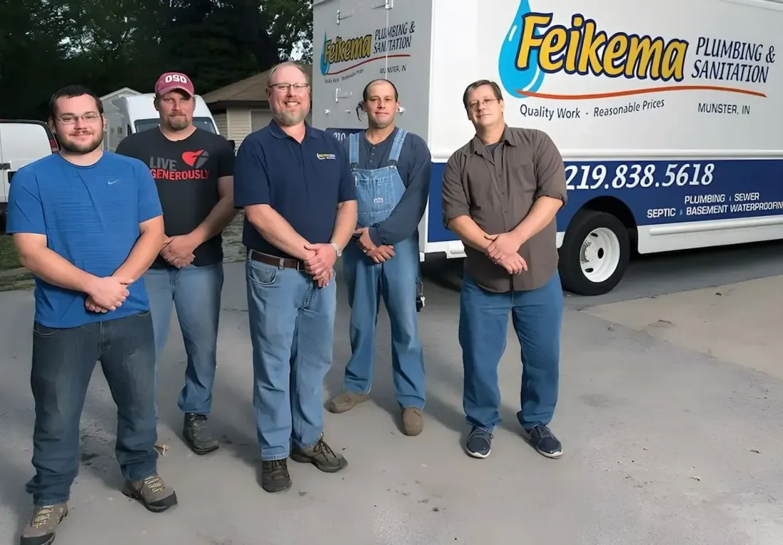 Four men standing outside a Feikema service truck in a parking lot.