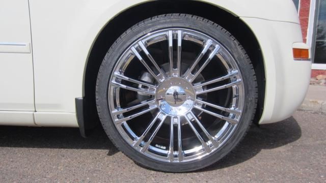 Close-up of a chrome car wheel and tire on a white vehicle