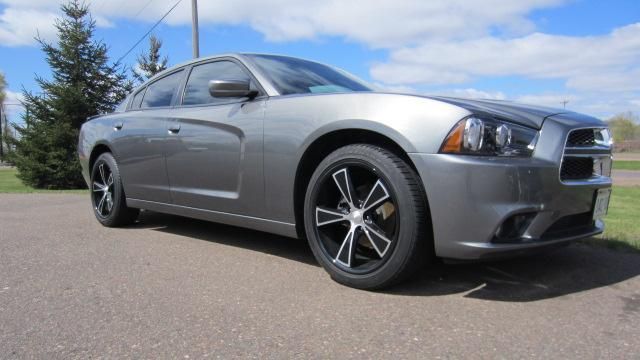 Silver Dodge Charger sedan parked on a road under a clear sky