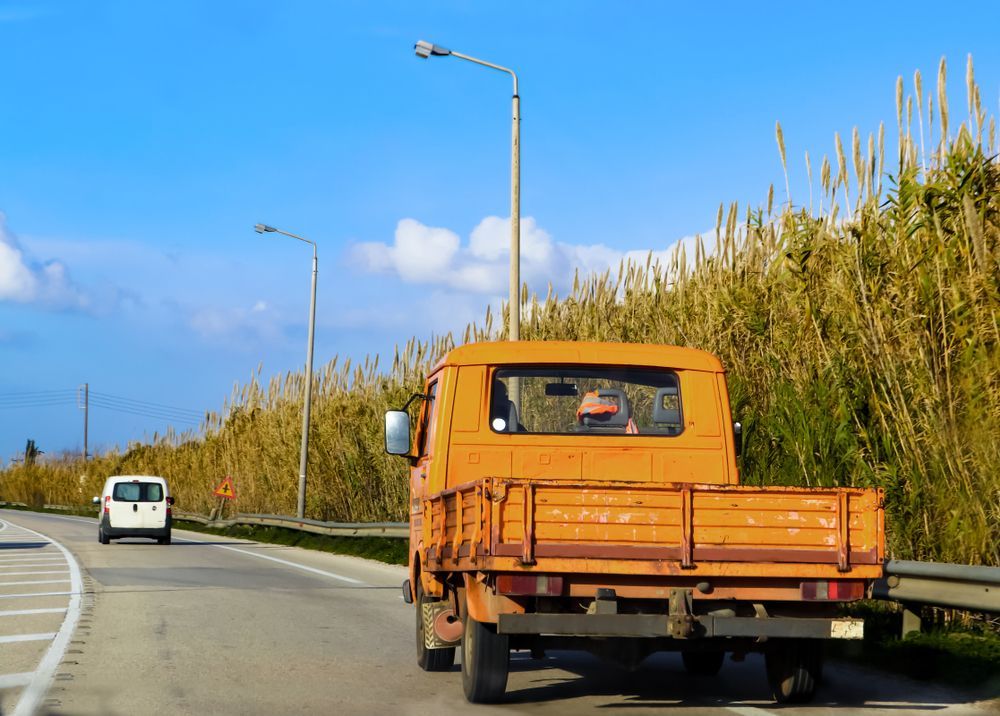 An Orange Flatbed Truck on Road — Aust. Advanced Trailer Sales & Service in Berrimah, NT